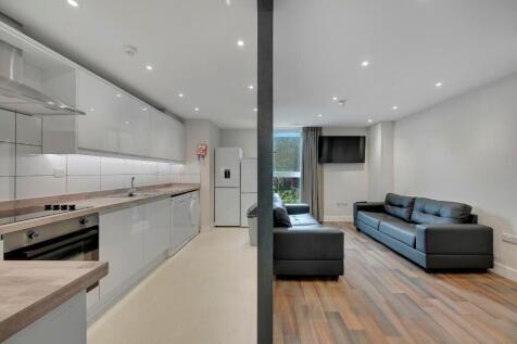 A modern, bright living room featuring sleek bl...