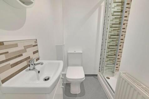 A modern and bright bathroom featuring a clean ...