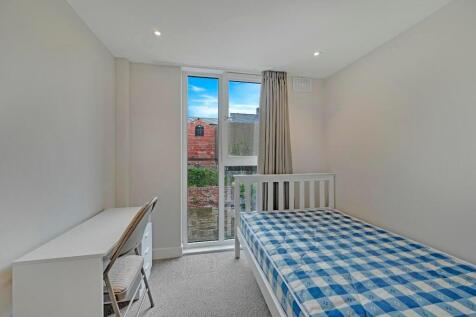 A bright and tidy single bedroom featuring a co...