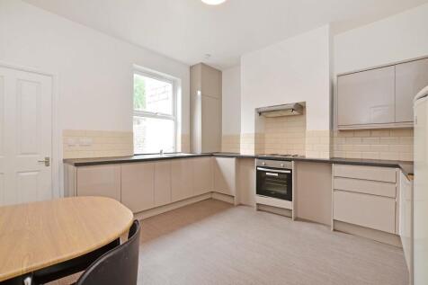 Bright and modern kitchen featuring sleek cabin...
