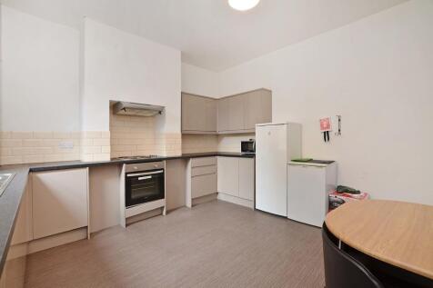 Bright and tidy kitchen featuring modern applia...
