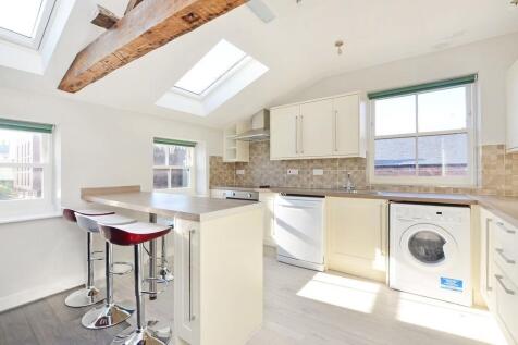 Bright and modern kitchen featuring ample natur...