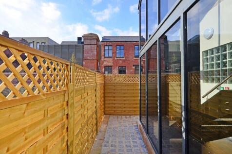 A bright and well-maintained garden space featu...