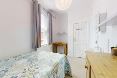 Bright and tidy small bedroom featuring a singl...