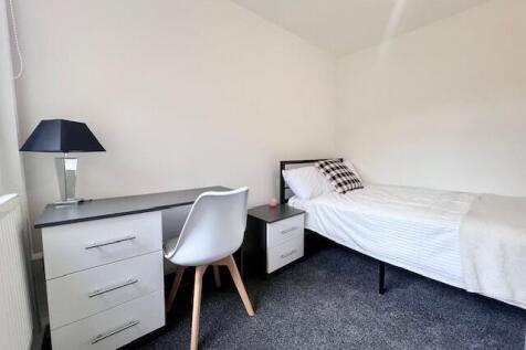 A neat and bright single bedroom featuring a co...