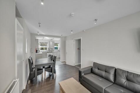 Modern living room with a comfortable black lea...