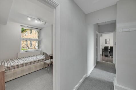 Bright and tidy hallway with neutral decor lead...