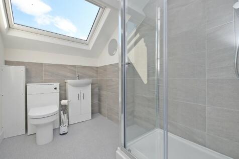 A modern and bright bathroom suite featuring a ...