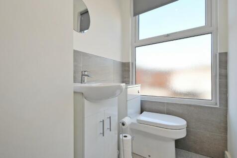 A modern bathroom featuring a white sink with c...