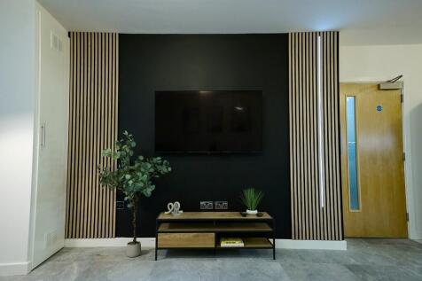 A modern living room featuring a sleek black ac...