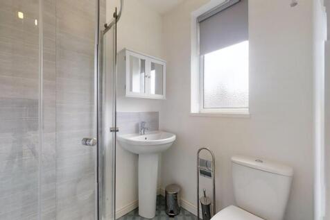 Bright and modern bathroom featuring a spacious...