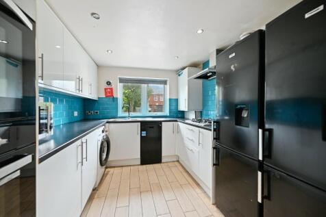 Bright and modern kitchen featuring sleek white...