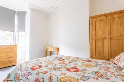 Bright and cozy double bedroom featuring a colo...