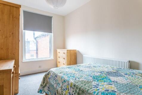 Bright and cozy double bedroom featuring a comf...