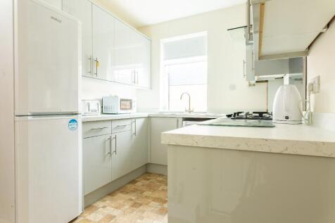 Bright and modern kitchen featuring ample cabin...