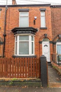A charming terraced brick house featuring a tra...