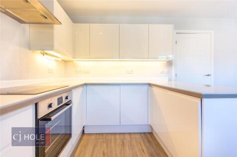 Modern and bright kitchen featuring sleek white...
