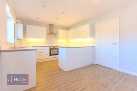 Bright and modern kitchen featuring sleek white...