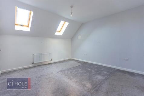 Bright double bedroom featuring skylight window...