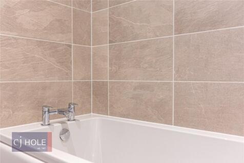 A modern bathroom featuring a clean white batht...