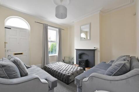 A bright and cozy living room featuring two com...