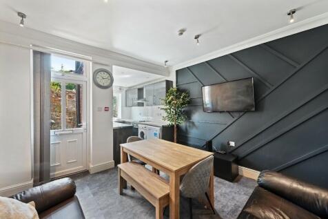 Bright and modern living room featuring a styli...