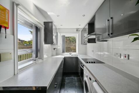 Bright and modern kitchen featuring sleek grey ...