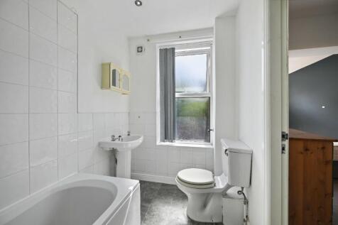 Bright and clean bathroom featuring a white bat...