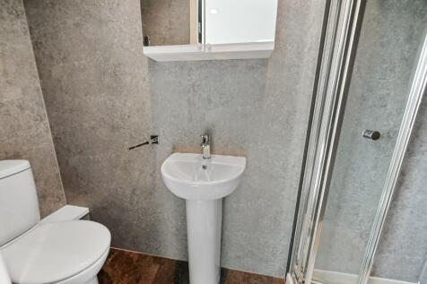A modern bathroom featuring a clean white pedes...