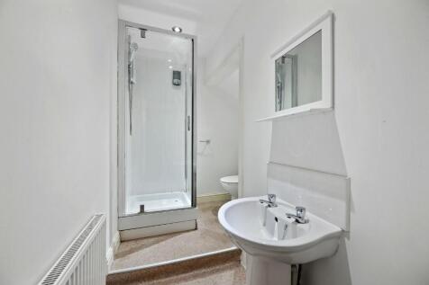 Bright, modern bathroom featuring a clean white...