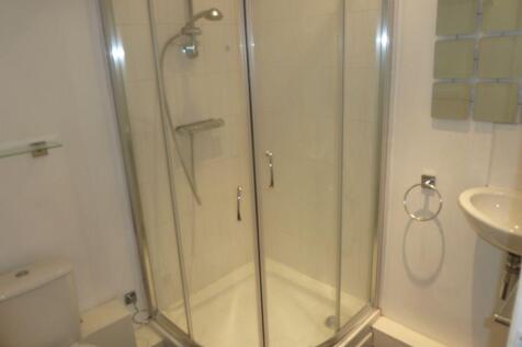 A clean and modern bathroom featuring a curved ...
