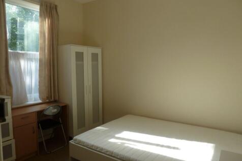 Bright single bedroom featuring a large window ...