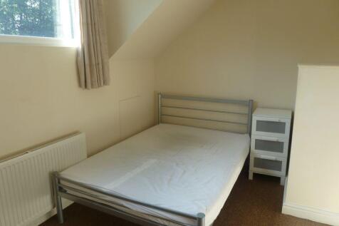 A simple and neat single bedroom featuring a me...