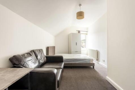 A bright and airy master bedroom featuring a co...