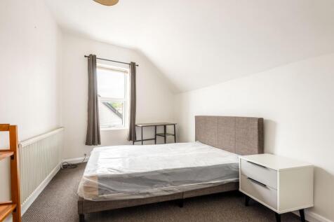 Bright and airy double bedroom featuring a comf...