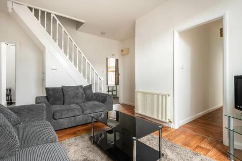 A cozy living room featuring comfortable grey s...