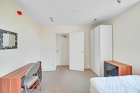 A bright and tidy master bedroom featuring a co...