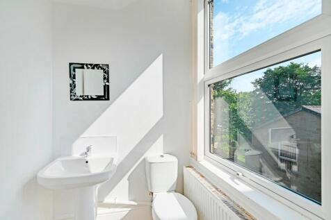 Bright and clean bathroom featuring a large win...