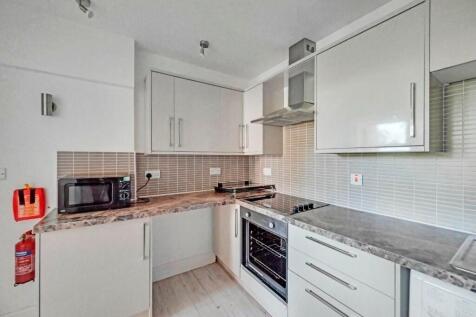 Bright and modern kitchen featuring ample count...