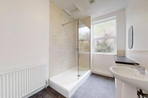 Bright and modern bathroom featuring a spacious...