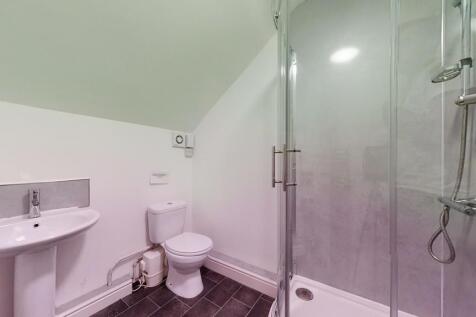 A clean and modern bathroom suite featuring a s...
