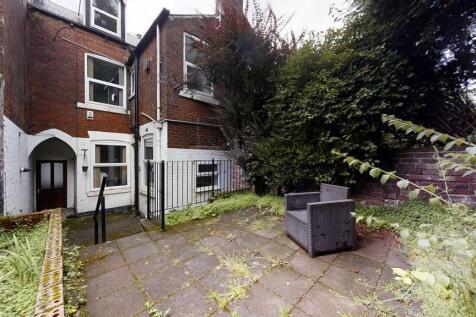 A private garden space featuring a paved patio ...