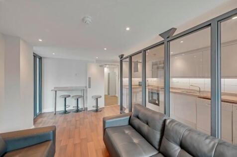 A modern living room featuring sleek leather so...