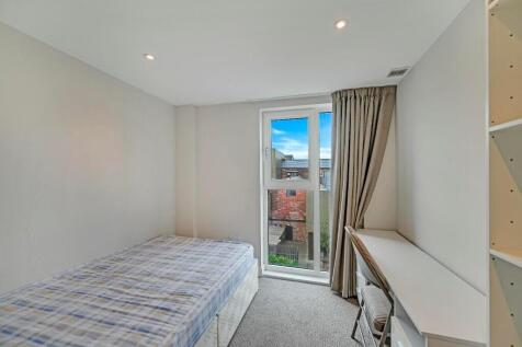A clean and bright single bedroom featuring a c...