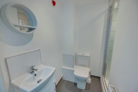 Bright and clean bathroom featuring a modern si...