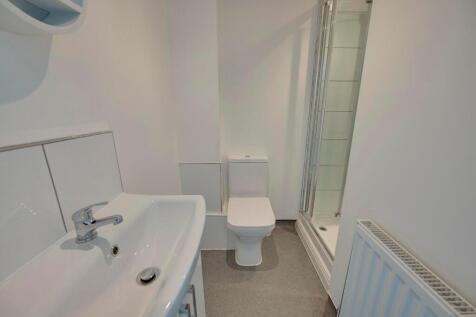 A clean and modern bathroom featuring a white s...