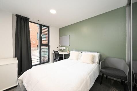 Bright and modern bedroom featuring a comfortab...