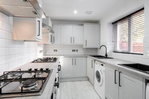 Modern kitchen featuring sleek cabinetry, ample...