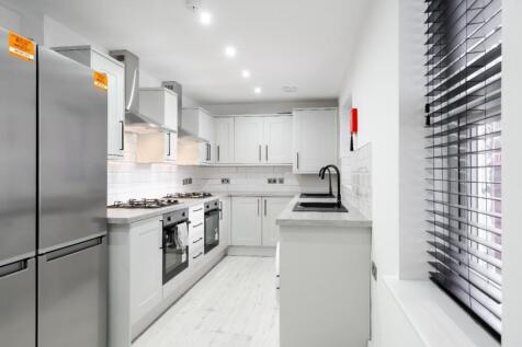 Modern and stylish kitchen featuring sleek cabi...