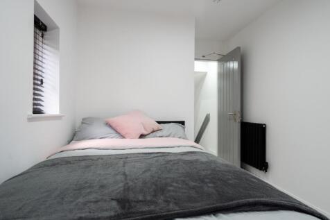 Cozy double bedroom featuring a comfortable bed...